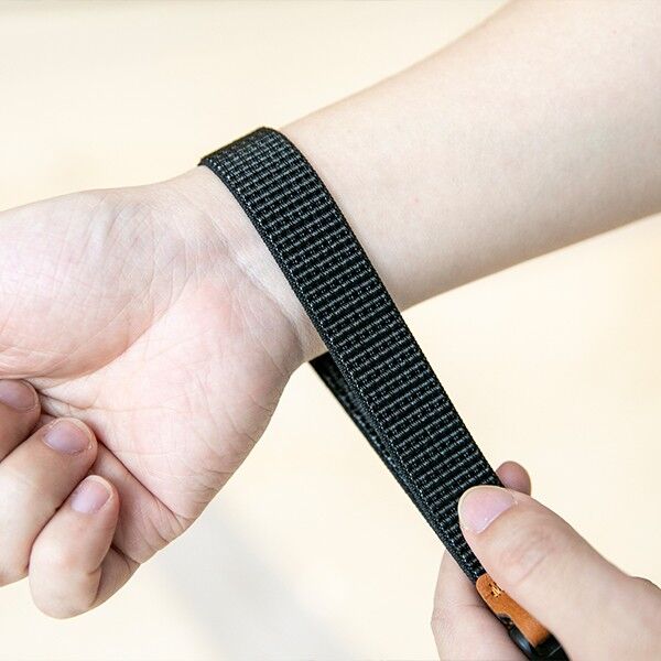 Close-up of the woven nylon texture of the Haida wrist strap in black